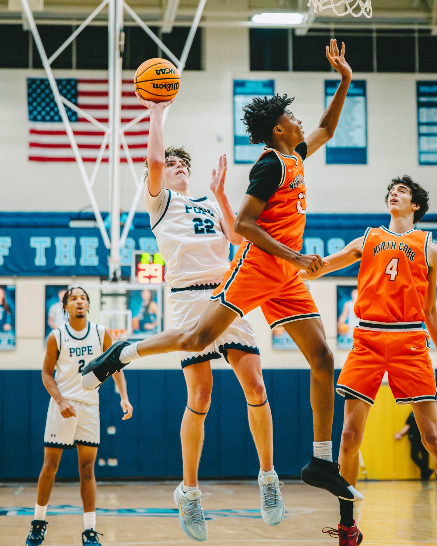 Basketball player attempting a contested layup