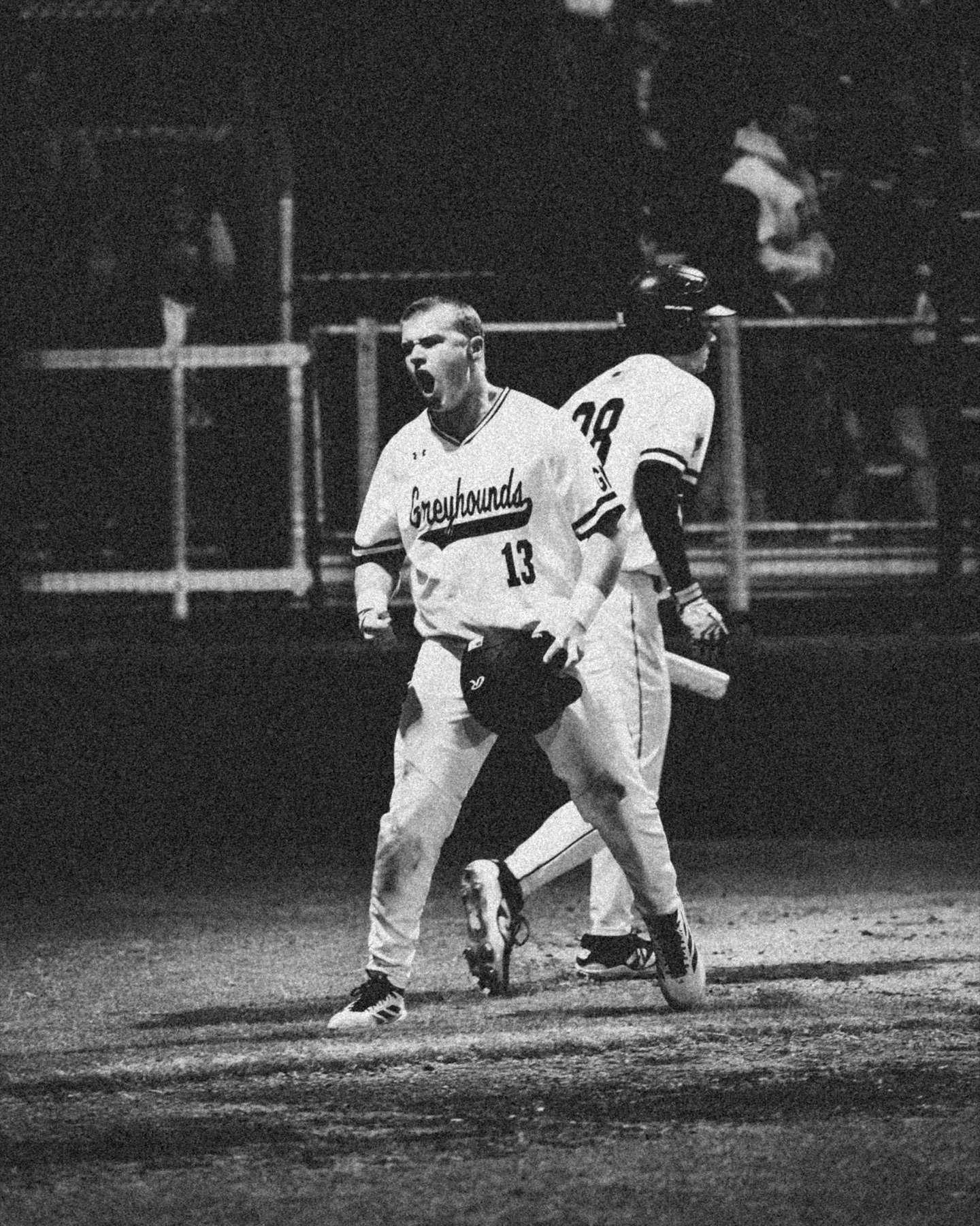 Baseball player celebrating in black and white
