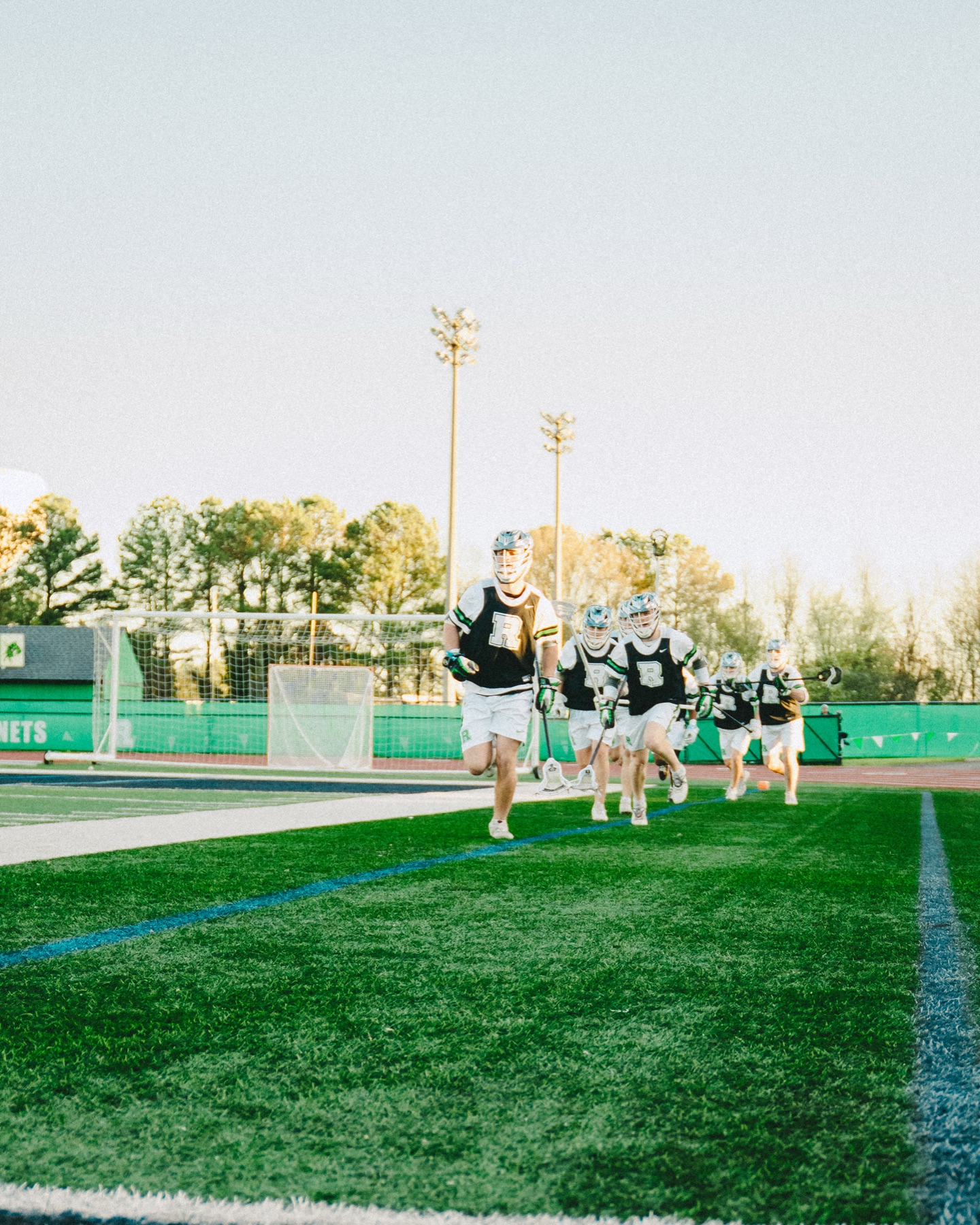 Lacrosse team running onto the field