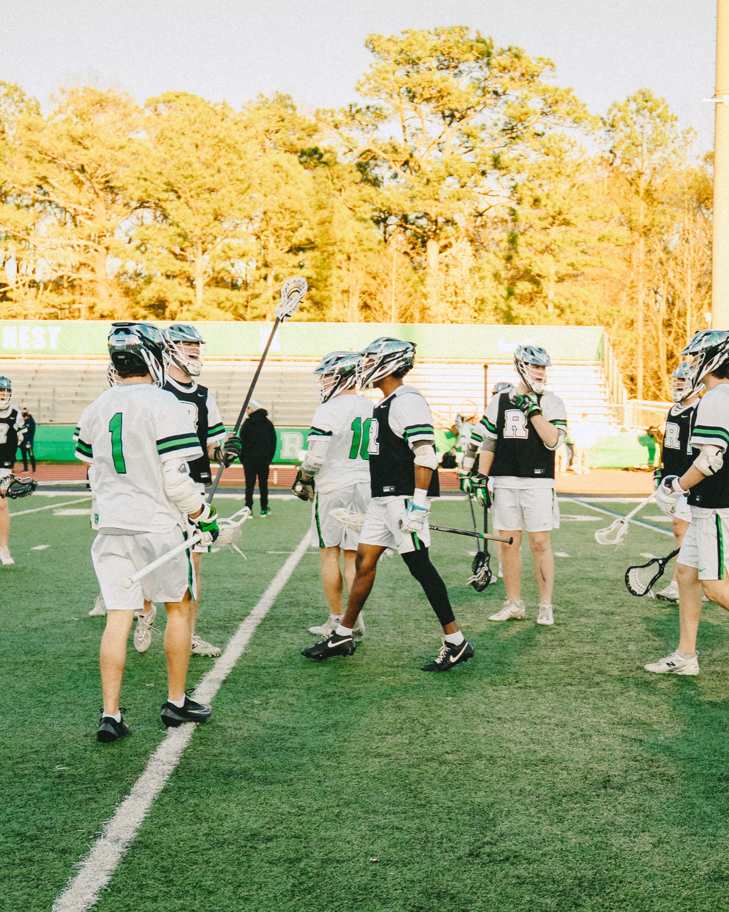 Lacrosse teammates gathering on the field
