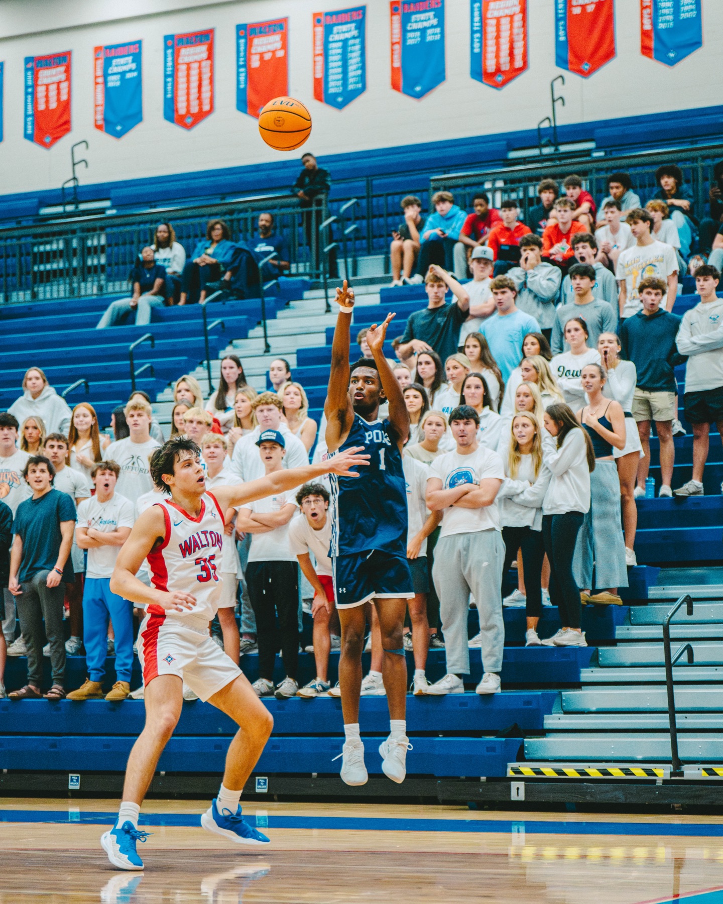 Basketball player shooting over a defender